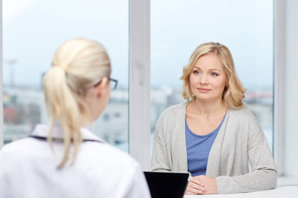 A doctor talking to a patient about a hysterectomy procedure at Healthy Connections.