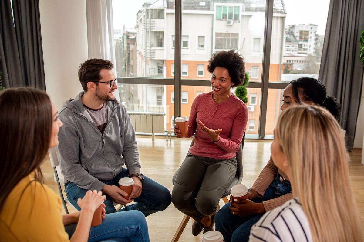 A group of people talking during therapy services with Healthy Connections