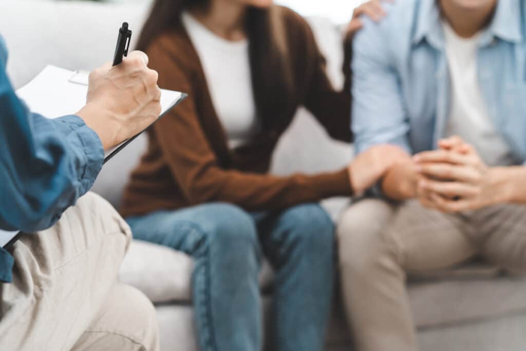 A woman comforting her partner during therapy services at Healthy Connections.