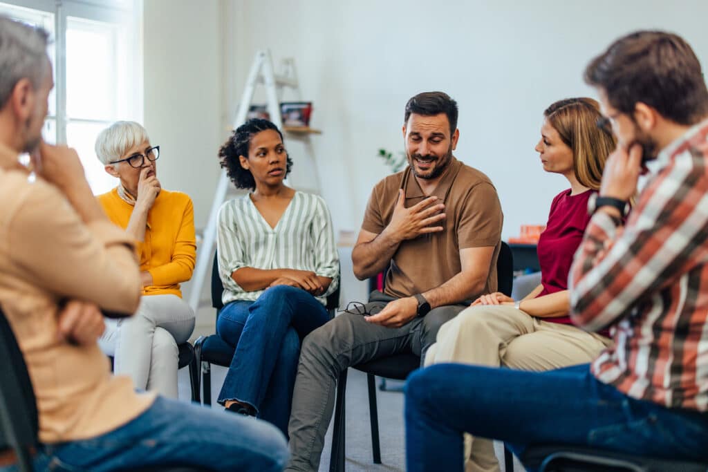 A man talking to his group in the MAT program.