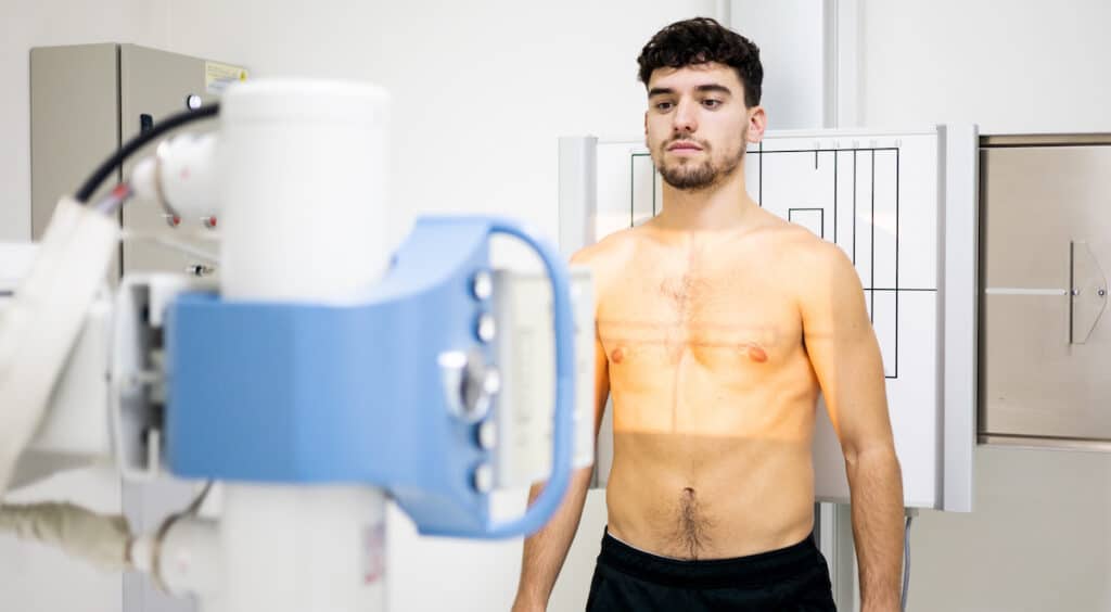 A young man receiving an X-Ray as part of Healthy Connections Radiological services.
