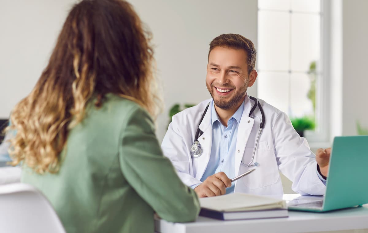 A doctor meeting with a patient to talk about LGBTQ+ Care.