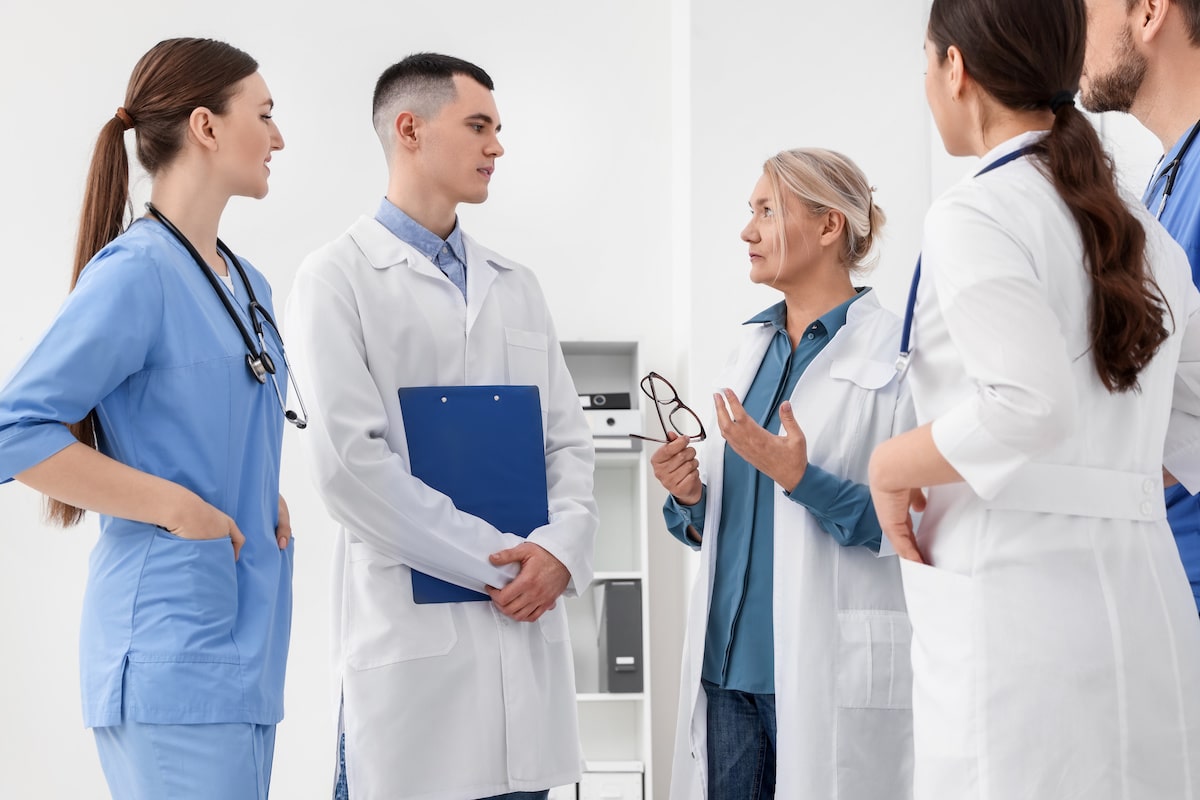 A group of doctors and nurses discussing in a clinic.