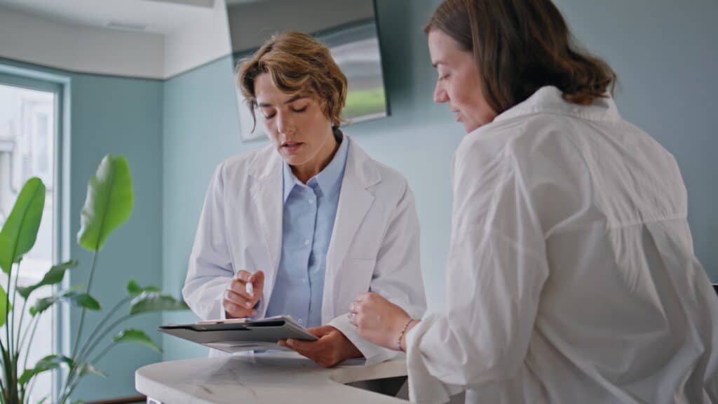 Medical workers reviewing paperwork in modern clinic.