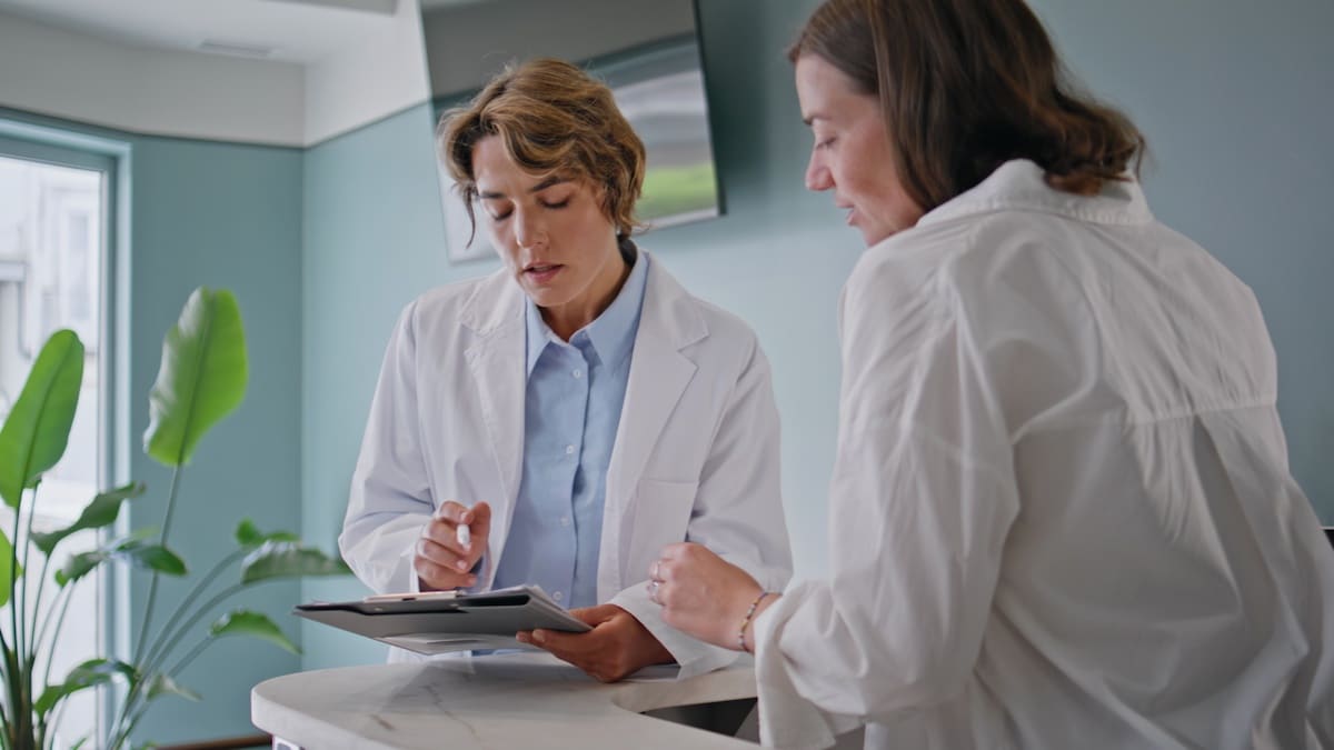 Medical workers reviewing paperwork in modern clinic.