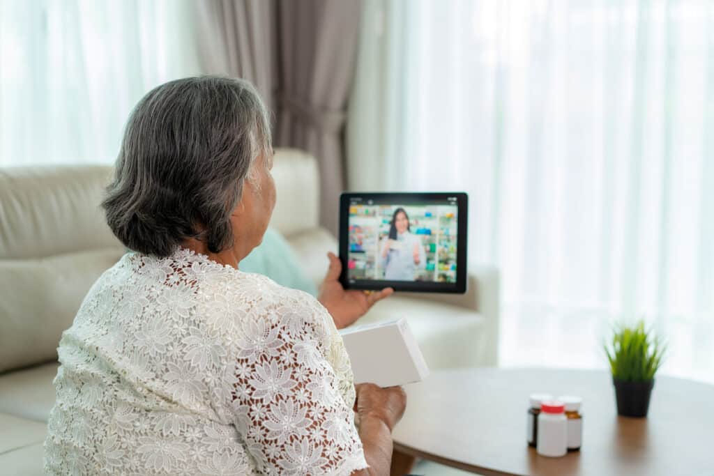 Senior woman talking to her pharmacist over Telehealth.
