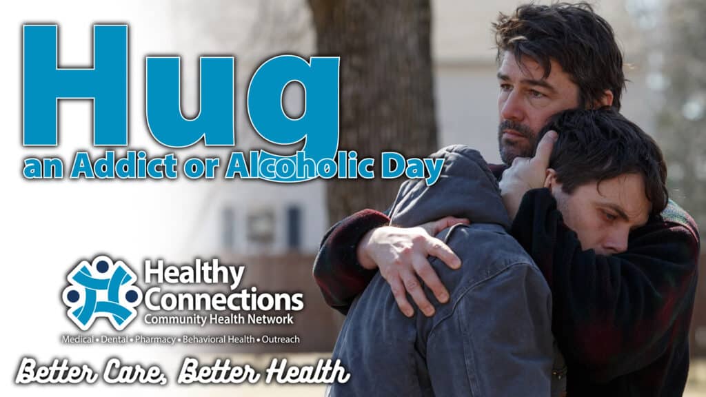 Hug an Addict of Alcoholic Day graphic with an image of a man hugging his son.